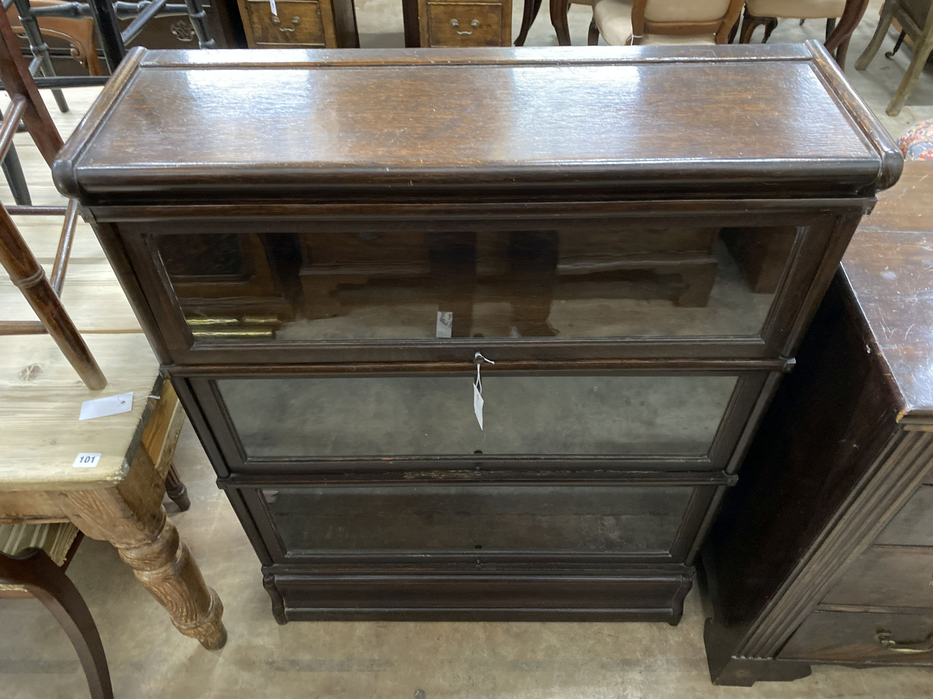 A Globe Wernicke three section glazed oak bookcase, length 86cm, depth 27cm, height 115cm